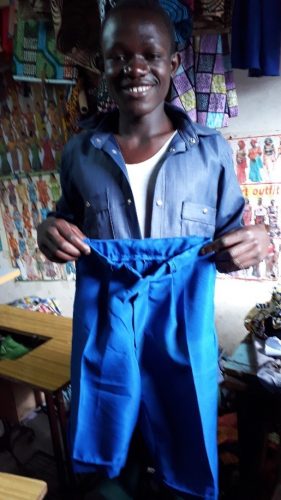 One of the tailoring students who is very proud of the school shorts that he has made.